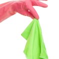 Hand in a pink glove holding green cloth isolated over white background